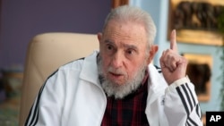 FILE - Cuba's Fidel Castro speaks with Russia's President Vladimir Putin in Havana.