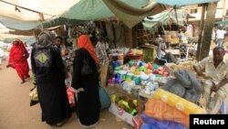 Women wait to shop for Ramadan at a central food market in Khartoum, Sudan, July 18, 2012. 