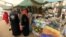 Women wait to buy things for Ramadan at a central food market in Khartoum, Sudan, July 18, 2012. 