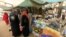 Women wait to shop for Ramadan at a central food market in Khartoum, Sudan, July 18, 2012. 
