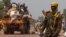 A Chadian soldier, part of the African Union (AU) peacekeeping mission in the Central African Republic, keeps guard during the beginning of a road repatriation to Chad in the capital Bangui, Jan. 22, 2014. 