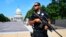 Capitol Hill Police officer Nathan Rainey stands guard on Capitol Hill in Washington, after House Majority Whip Steve Scalise of Louisiana was shot during a congressional baseball practice in Alexandria, Va., June 14, 2017.