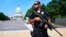FILE - Capitol Hill Police officer Nathan Rainey stands guard on Capitol Hill in Washington, after House Majority Whip Steve Scalise of Louisiana was shot during a congressional baseball practice in Alexandria, Virginia, June 14, 2017.