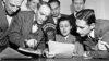 FILE - A group of State Department announcers huddle around the microphone after the initial shortwave broadcast in Russian to Russia from New York City, Feb. 17, 1947.