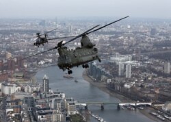 FILE - A Royal Air Force Chinook flies over London during the Service of Commemoration – Afghanistan, at St Paul's Cathedral in London, March 13, 2015.