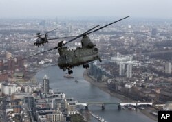 FILE - A Royal Air Force Chinook flies over London during the Service of Commemoration – Afghanistan, at St Paul's Cathedral in London, March 13, 2015.