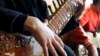 FILE - In this Jan. 7, 2013 file photo, an Afghan girl practices playing the sitar in a class at the Afghan National Institute of Music, ANIM, in Kabul, Afghanistan. 