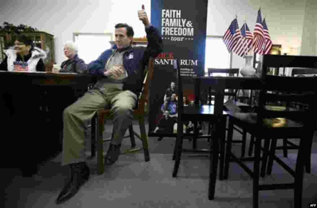 Republican presidential candidate former Pennsylvania Sen. Rick Santorum gestures as he waits to speak to local residents during a campaign stop at USA Furniture and Bedding, Wednesday, Dec. 28, 2011, in Dubuque, Iowa. (AP Photo/Charlie Neibergall)