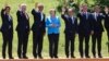 German Chancellor Angela Merkel (C) poses with G7 leaders during a group photo at the G-7 summit at Schloss Elmau near Garmisch-Partenkirchen, southern Germany, June 7, 2015.