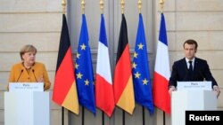 French President Emmanuel Macron and German Chancellor Angela Merkel attend a joint news conference at the Elysee Palace in Paris, France, Feb. 27, 2019. 