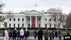 The US flag flies at half-staff at the White House in tribute to former US President George H. W. Bush, on December 1, 2018, in Washington, DC. (Photo by Katie SCHUBAUER / AFP)