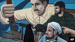 FILE - A woman walks past of a mural depicting members of Iran's Basij volunteer paramilitary force, in downtown Tehran, Jan. 3, 2018. 