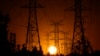 FILE - The sun sets behind high tension power lines on Sept. 23, 2024, in the Porter Ranch section of Los Angeles. The U.S. economy grew at a healthy 2.8% annual rate from July through September, the Commerce Department says.