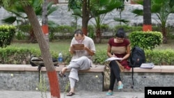 FILE - Indian students study inside the Delhi University campus in New Delhi. Sept. 20, 2013. 