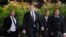 FILE - Tesla CEO Elon Musk, second from left, arrives at U.S. District Court in Los Angeles, Dec. 4, 2019. 