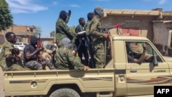 (FILE) Supporters of the Sudanese armed popular resistance, which backs Sudan's army, ride on trucks in Gedaref in eastern Sudan on March 3, 2024.