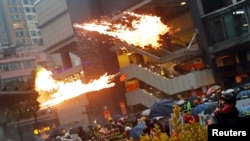 An anti-extradition bill protester throws a Molotov cocktail as protesters clash with riot police during a rally to demand democracy and political reforms, at Tsuen Wan in Hong Kong, Aug. 25, 2019.