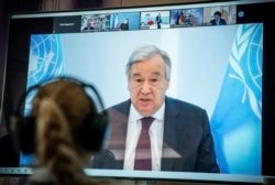 Antonio Guterres, U.N. secretary-general, is seen on a screen at the Environment Ministry as he delivers his speech at the Petersberg Climate Dialogue, in Berlin, Germany, April 28, 2020.