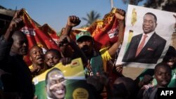 Supporters of the newly elected Zimbabwe President Emmerson Mnangagwa celebrate in Mbare, Harare, Aug. 3, 2018. Mnangagwa, a former ally of Robert Mugabe, won 50.8 percent of the vote, ahead of Nelson Chamisa of the opposition MDC party at 44.3 percent, the Zimbabwe Electoral Commission (ZEC) said.