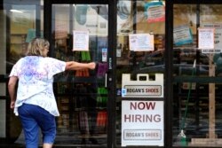 FILE - A hiring sign is on display at a retail store in Buffalo Grove, Ill., June 24, 2021.