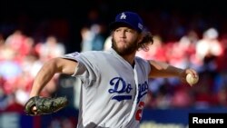 FILE - Los Angeles Dodgers starting pitcher Clayton Kershaw throws a pitch against the St. Louis Cardinals.