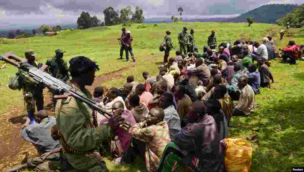 Congolese soldiers guard suspected M23 rebel fighters who surrendered in Chanzo village near the eastern town of Goma, Nov. 5, 2013.