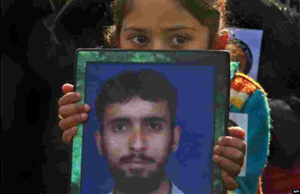 A Kashmiri Muslim girl holds a photo of her missing relative during a protest organized by Association of Parents of Disappeared Persons (APDP), in Srinagar, India, Wednesday, Nov. 10, 2010. According to APDP, more than 10,000 people have disappeared in t