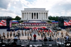 FILE - Two Bradley Fighting Vehicles flank the stage being prepared in front of the Lincoln Memorial in Washington, ahead of planned Fourth of July festivities with President Donald Trump, July 3, 2019.