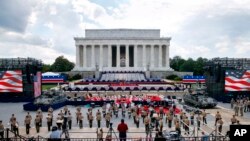 Two Bradley Fighting Vehicles flank the stage being prepared in front of the Lincoln Memorial, Wednesday, July 3, 2019, in Washington, ahead of planned Fourth of July festivities with President Donald Trump. 
