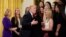 FILE - U.S. President Donald Trump hugs a member of the Oklahoma Women's Softball team as he greets members of Championship NCAA teams at the White House in Washington, Nov. 17, 2017. A new book by author Nina Burleigh will focus on Trump's relationships with women.