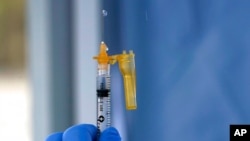 FILE - In this March 4, 2021, photo a syringe of the Moderna COVID-19 vaccine is shown at a drive-up mass vaccination site in Puyallup, Wash., south of Seattle.
