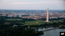 In this June 7, 2021, photo taken from the window of an American Airlines aircraft the Washington Monument is seen during a flight from Phoenix to Ronald Reagan Washington National Airport. 