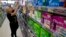FILE - Tammy Compton restocks tampons at Compton's Market, in Sacramento, Calif., June 22, 2016. Bills to exempt feminine hygiene products and diapers from sales taxes were vetoed by Gov. Jerry Brown in 2016, but the measure's author's are reintroducing the proposals.