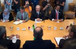 FILE - Libyan militia commander General Khalifa Haftar, top center, listens to Russian Foreign Minister Sergey Lavrov, bottom center, during their meeting in Moscow, Russia, Aug. 14, 2017.