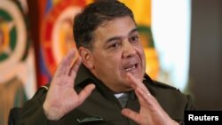 FILE - Colombian anti-narcotics police chief General Ricardo Restrepo gestures during an interview at the anti-narcotics military base in Bogota, Nov. 25, 2013.