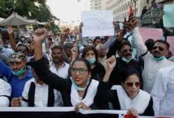 Pakistani Christians protest against child marriage and forced conversion, in Karachi, Pakistan, Nov. 8, 2020. Rights groups say each year in Pakistan, as many as 1,000 girls are forcibly converted to Islam, often after being abducted or tricked.