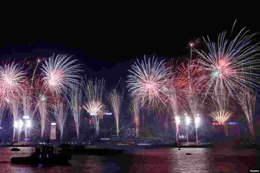 Fireworks explode over Victoria Harbor to celebrate the New Year in Hong Kong, China, Jan. 1, 2025. 