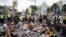 Anti-vaccination protesters sit in central London
