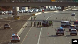 FILE - Traffic backs up on Interstate Highway 10 as authorities investigate a fatal accident in Phoenix, July 26, 2015. Drivers who miss two or three hours of sleep in a day face the same risk of an accident as those who are legally drunk, an AAA study found.