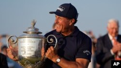 Phil Mickelson holds the Wanamaker Trophy after winning the final round at the PGA Championship golf tournament on the Ocean Course, in Kiawah Island, South Carolina, May 23, 2021. 