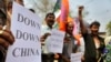 FILE - Activists gather in Guahati, India, March 21, 2012, to protest construction of dams in China in the Brahmaputra River. In December 2024, China approved construction of the world’s largest hydropower dam, to be built on that river, fueling fears in India and Bangladesh.