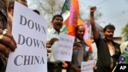 FILE - Activists gather in Guahati, India, March 21, 2012, to protest construction of dams in China in the Brahmaputra River. In December 2024, China approved construction of the world’s largest hydropower dam, to be built on that river, fueling fears in India and Bangladesh.