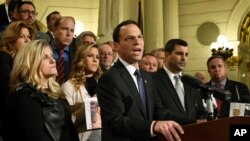 Attorney General Josh Shapiro of Pennsylvania speaks at a news conference in the state Capitol after legislation to respond to a landmark grand jury report accusing hundreds of Roman Catholic priests of sexually abusing children over decades stalled in the Legislature, Oct. 17, 2018 in Harrisburg, Pa. The U.S. Justice Department has opened an investigation of abuse allegations inside the church, according to two people familiar with the probe.