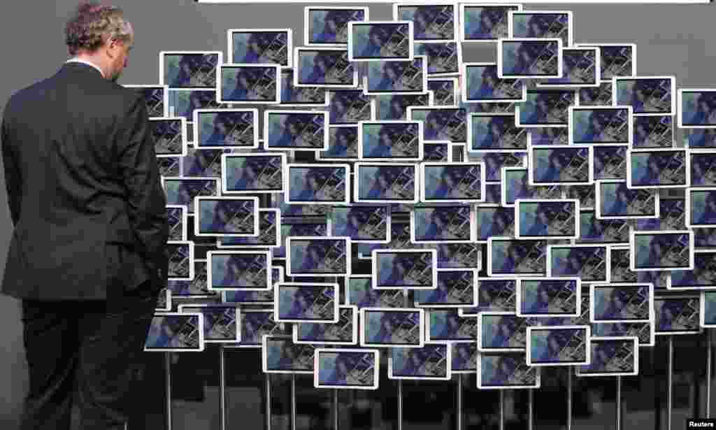 Franz Fitzek, a professor at the technical university of Dresden, stands in front of an installation of tablet computers at the CeBit trade fair in Hanover, Germany.