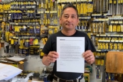 Albert Chow, owner of Great Wall Hardware in San Francisco, Aug. 28, 2019, holds a letter from a supplier notifying him that prices will be increasing 10% to 18% because of U.S. tariffs on Chinese goods.