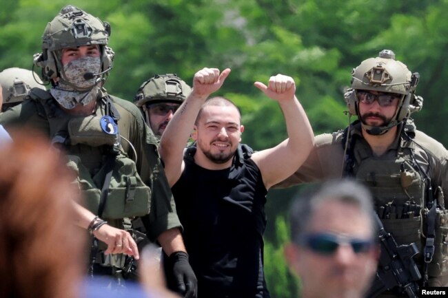 Almog Meir Jan, 22, kidnapped from Israel in a Hamas-led attack on Oct. 7, 2023, raises his hands after arriving by helicopter to the Sheba Medical Center in Ramat Gan, Israel, June 8, 2024.