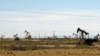 FILE - Oil rigs stand in the Loco Hills field on Apr. 9, 2014, on in Eddy County near Artesia, N.M..