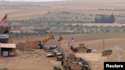 FILE - U.S. forces set up a new base in Manbij, Syria, May 8, 2018. 