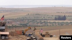 FILE - U.S. forces set up a new base in Manbij, Syria, May 8, 2018. 