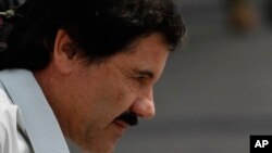 Joaquin "Shorty" Guzman is escorted to a helicopter in handcuffs by Mexican Marines at a Navy hangar in Mexico City, Feb. 22, 2014. 